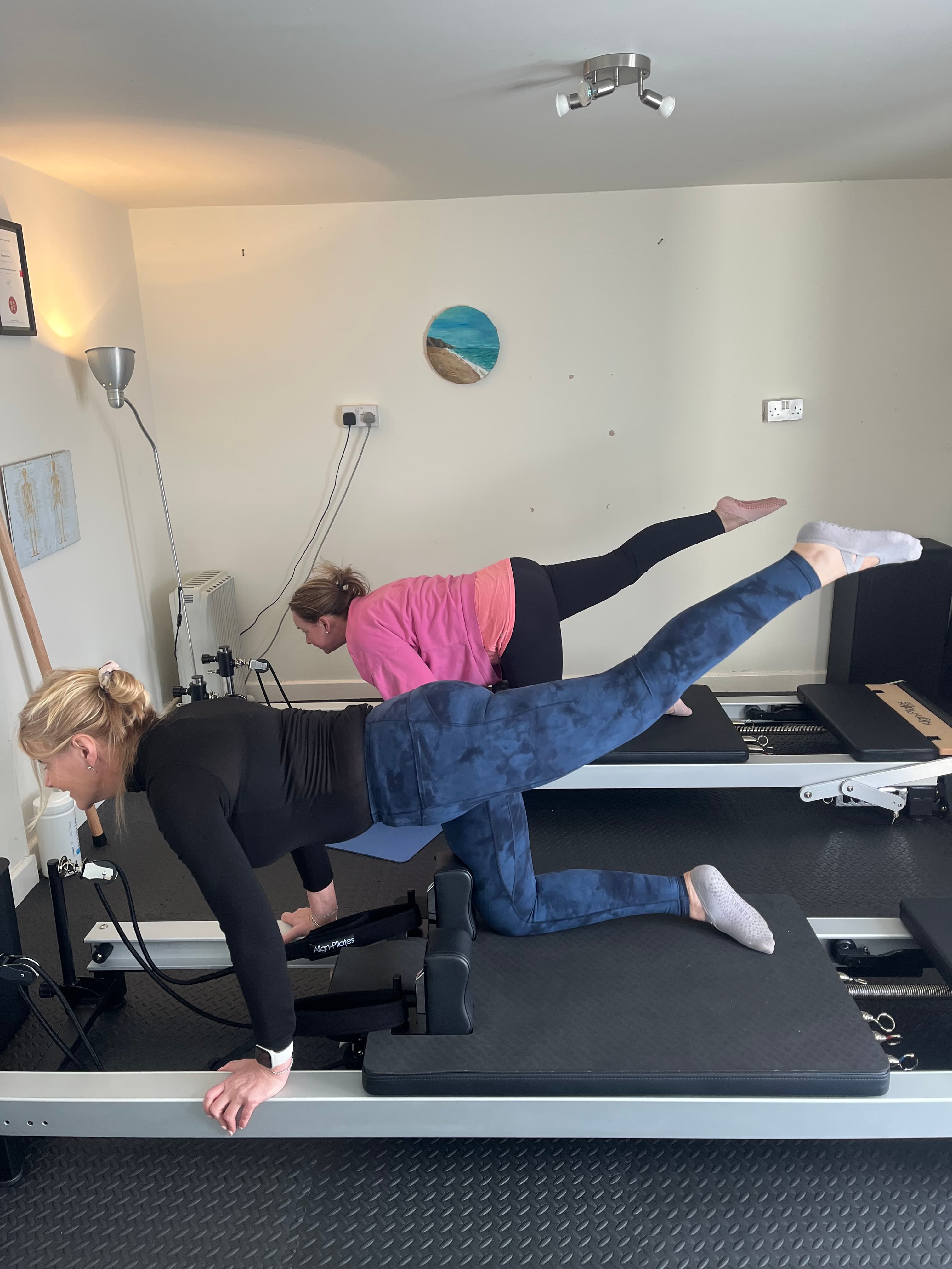 Client performing a shoulder bridge with legs extended on the reformer